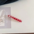 Close-up of red and white checkered hair clip with silver heart and lar mood text - Red Plaid