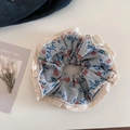 Detailansicht großes Scrunchie-Haargummi mit Spitze und blauem Blumenmuster - Blau