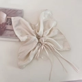 Dettaglio di elastico a fiocco crema in tessuto perlato con strass e nastri pendenti - 2#Beige