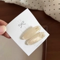 Detailed macro view of retro oval acetate hair clips with pearlescent finish on display card - 7# Mermaid White