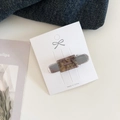 Rectangle tortoise shell hair clip with silver metal base on a white display card - Khaki