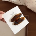 Detailed macro of tortoiseshell acetate hair clips with France Handmade gold lettering - Blue Coffee