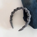 Detail shot of black and white checkered fabric headband with inner non-slip plastic teeth - Black and White Check