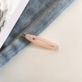 Detailed macro of pink acetate hair clip with rhinestones and metal spring mechanism - Apricot Pink