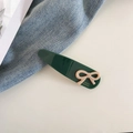 Detail of dark green acetate hair clip with pink bow and France Handmade text - Dark Green
