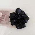 Close-up of a large black satin scrunchie with a soft glossy texture and elegant pleats - 4# Black