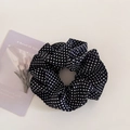 Detail view of a navy blue polka dot scrunchie with soft ruffled fabric texture - 3# Black Polka Dot Scrunchie