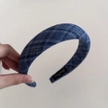 Detail view of retro navy blue checkered headband with textured fabric and inner brand label - Wide Headband / Navy Plaid