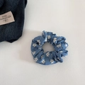 Detailed macro view of denim blue scrunchie with white floral embroidery on cotton linen - Small Hoop / Light Blue Floral