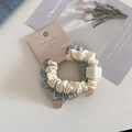 Close-up of dual-tone scrunchie with square bead and gold charm on brand paper card - Two-Piece Set / Light Green Series