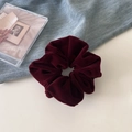 Detail shot of a vintage deep red velvet scrunchie on blue denim with soft lighting - Burgundy