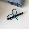 Detail of blue acetate bow hair clip with gold France Handmade lettering on black base - Green