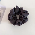 Detail of grey scrunchie with red heart patterns and stitched edges on white background - Gray