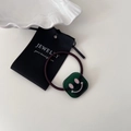 Elastic hair tie with a square dark green translucent bead featuring a pink smiley face - Dark Green
