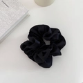 Detail of a black double-layered satin hair scrunchie with soft silk texture and pleats - Black