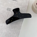 Détail d'une pince à cheveux noire brillante avec strass colorés sur un livre - Forme en I (5539989585099)