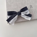 Grey fabric bow hair clip with white lace trim on a book for a minimalist aesthetic - Double Layer Handmade Style (JH-0342)