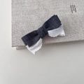 Detail of grey denim and white lace bow hair clip on a textured book surface - Denim Texture Style (JH-0342)
