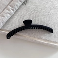 Matte black large claw clip for thick hair displayed on a minimalist linen background - Black