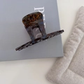 Detail of tortoise shell acetate hair claw clip featuring gold France Handmade logo - Blue Coffee