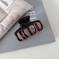 Detail showing the brown tortoiseshell hair claw clip with France Handmade engraving - Dark Coffee