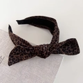 Detail of velvet leopard print headband featuring a twisted knot and soft fabric texture - Dark Leopard Bowknot Style