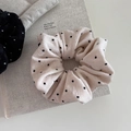 Close-up of soft velvet polka dot hair scrunchies on a minimalist background - Gentle Beige
