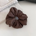 Detail showing the thick, soft texture of the dark brown puffy cloud scrunchie - Coffee