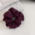 Detailed view of dark purple puffy scrunchie showing premium pleated fabric texture - Angola Red