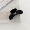 Detail of matte black French hair claw with gold lettering on a linen texture - Small Half-round / Black - Small Semi Round