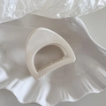 Detail view of a minimalist cream white semicircular hair claw on a white ceramic plate - Small Semi-circle Shape - White