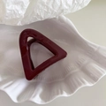 Macro shot of a dark red triangular hair claw clip placed on a white shell porcelain plate - Small Triangle Shape - Red