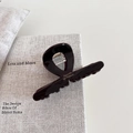 Macro detail of glossy chocolate acetate hair claw with gold Barrette La France lettering - 2# Dark Coffee