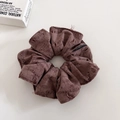 Detail of distressed brown scrunchie with frayed edges and For Love woven label tag - Brown
