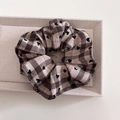 Detailed close-up of brown and beige plaid scrunchie with embroidered black hearts - Brown Grid - Scrunchie Style