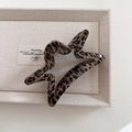 Detailed view of a star-shaped leopard print hair claw clip in a warm beige display box - Star Style (5#)