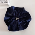 Detail of navy blue velvet scrunchie showing premium texture and branded label - Navy Blue