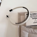 Detail view of beige fabric headband showing non-slip plastic teeth and soft end tips - 1# Creamy White