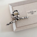 Detailed view of metal hair claw clip featuring zebra pattern fabric and golden spring - White Zebra Pattern Cross Style