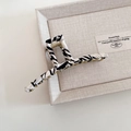 Detail of golden metal hair claw clip with black and white zebra pattern satin wrapping - White Zebra Pattern Hanger Style