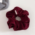 Detail shot of wine red knitted scrunchie with a Hand Made label on fabric - Ancorra Red