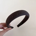 Close-up of thick grey polka dot headband with padded twill fabric and interior brand label - Coffee/Brown