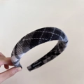 Detail of wool blend plaid headband with Hand Made label and vintage fabric texture - Black and White Plaid