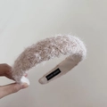 Detail showing plush beige faux fur texture and handmade label inside the wide headband - Apricot