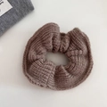 Close-up of brown knit scrunchie with ribbed texture for elegant low ponytail hair styles - Brown
