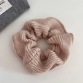 Detail of soft knit texture on a dusty pink oversized scrunchie for winter hair styling - Apricot