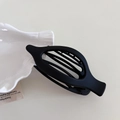 Minimalist matte black oval hair clip with hollow design and inner teeth for styling - Matte Black
