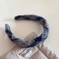 Close-up of retro plaid tweed headband with blue and beige knitted texture detail - Blue Series - Sponge Headband