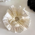 Close-up detail of double-layer cream satin scrunchie with elegant pleated ruffles texture - Beige Apricot