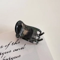 Macro detail of marble pattern hair claw clip with golden La France elegant lettering - Ink Green